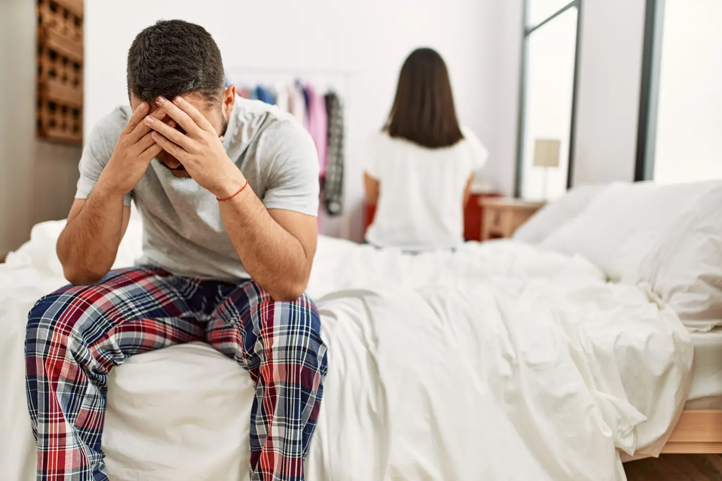 Young Latin Couple Trouble Sitting Bed With Hands Head